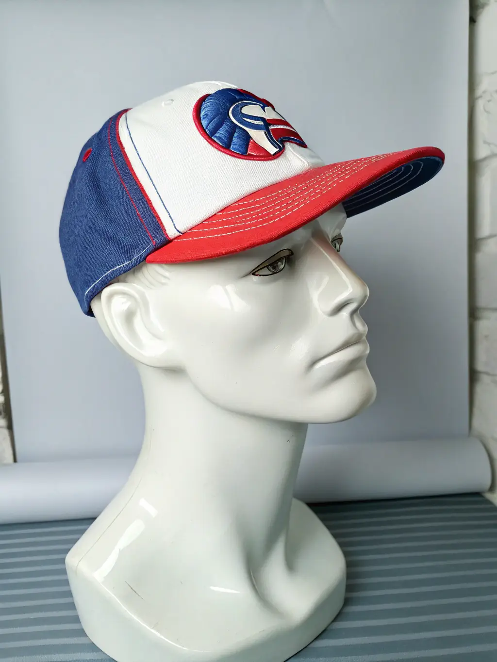 A sleek, modern design of a Master Bryson AI branded baseball cap, featuring the logo embroidered on the front. The cap is displayed on a mannequin head against a neutral background.